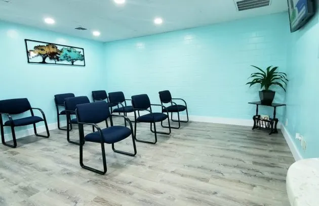 Waiting area with chairs and a television screen