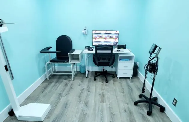 Exam room with a blood-draw chair, a scale and vital-signs equipment