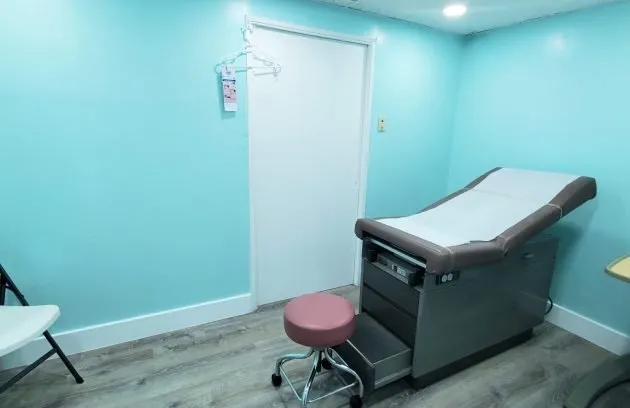 Exam room with a medical exam table and a stool