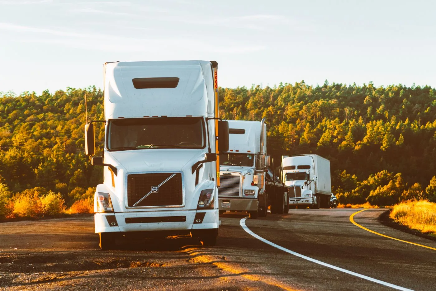 White freight truck on a highway at sunset